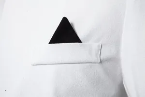 Men's suit jacket pocket detail, stylish white and black color block close-up view.
