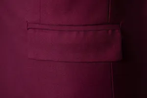 Men's burgundy suit jacket pocket detail, fine twill fabric professional close-up view.