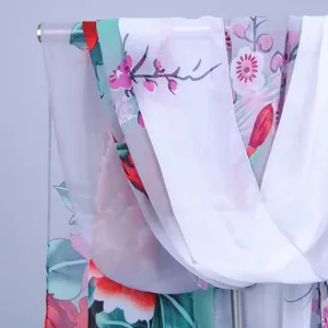 Exquisite floral chiffon scarf detail, showing delicate print texture and lightweight summer sun