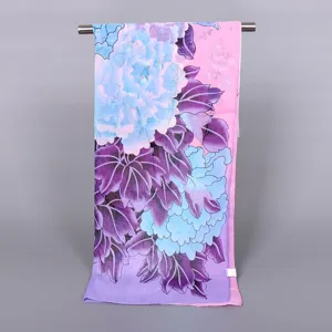 Detailed view of a floral printed chiffon scarf featuring blue peonies and purple gradient.