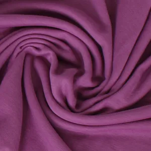 Close-up detail of smooth purple stretch jersey fabric, showing soft texture and fine drape.