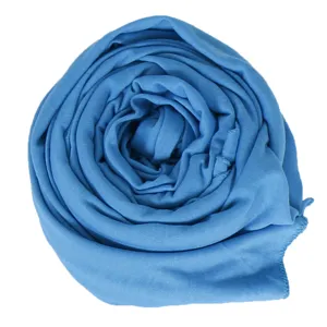 Close-up shot showing the soft, stretchy texture and vibrant blue color of the woven scarf fabric.