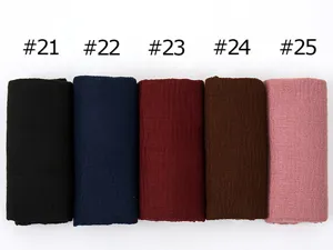 Detail view of the cotton linen pleated scarf showing multi-color fabric variants.