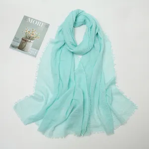 Mint green cotton linen crinkled scarf with frayed edges, soft lightweight long shawl.