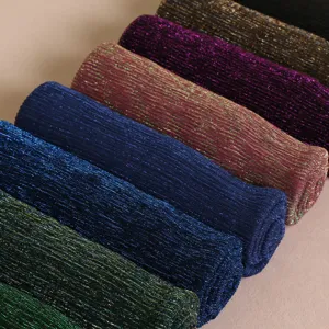 Detailed view of shimmering metallic pleated women scarves rolled neatly in vibrant multi colors.