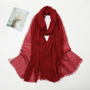 Red crinkled cotton linen scarf with fringed edges, stylish lightweight summer shawl.