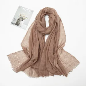 Detailed view of the cotton linen crinkled scarf featuring soft texture and frayed edges.