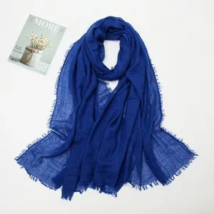 Detailed view of the blue crinkled cotton linen scarf featuring stylish fringe edges.