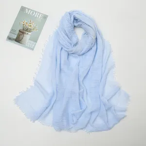 Light blue cotton linen crinkle scarf with frayed fringe edges for women daily wear.