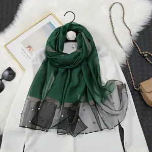 Detailed view of dark green gradient organza scarf with pearls and shiny lines, elegant design.