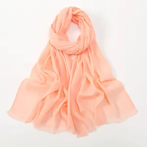 Detailed close-up view of the soft slub cotton scarf highlighting texture and tassel edges.