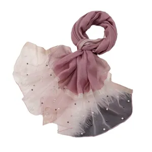 Elegant women's long scarf featuring pearl embellishments and layered organza design for travel.