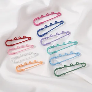 Colorful decorative safety pins closeup, stylish waist-tightening clips for dresses and clothes.