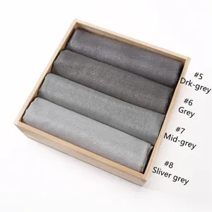 Solid color metallic rayon scarf detailed view showing various grey color options neatly rolled.