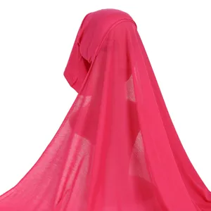Detail shot of solid pink all-in-one hijab scarf cap, showing fabric drape and style.