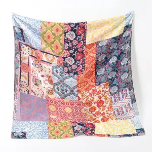 Close-up detail of the vintage patchwork silk scarf featuring vibrant floral patterns.
