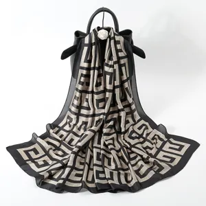 Luxury black and gold geometric print silk scarf, elegant long shawl for women and sun protection.
