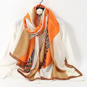 Elegant orange and white silk scarf with geometric print, premium satin long shawl for women.