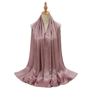 Crinkled satin hijab long scarf for women, silky draped shawl in elegant dusty pink color.