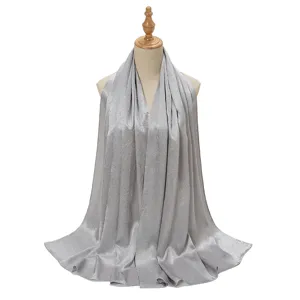 Detail view of the silver crinkle satin hijab, showcasing smooth texture and fine pleats.