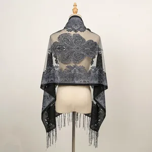 Detailed back view of a summer thin lace shawl with elegant burn-out paisley pattern and chic tassels.