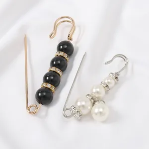 Detailed view of elegant pearl rhinestone anti-glare brooch safety pins for dress waist tightening.