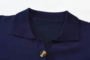 Detailed close-up shot of dark blue knitted polo shirt collar and button placket design.