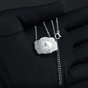 Macro view of the engraved letter A on an ornate belt buckle pendant necklace