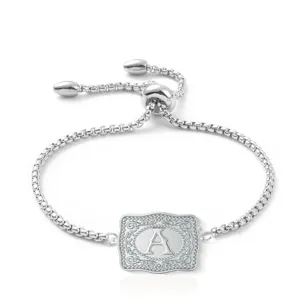 Close-up of embossed silver rectangle charm with letter A on adjustable bolo bracelet