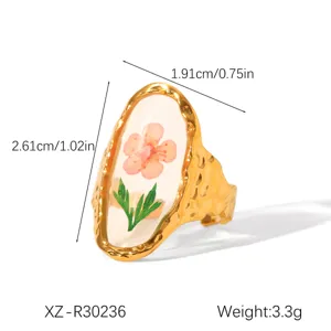 Detailed view of gold hammered ring with dried pink flower in resin and dimensions