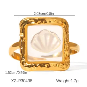 Detailed macro shot of a gold-plated stainless steel shell ring with size specifications
