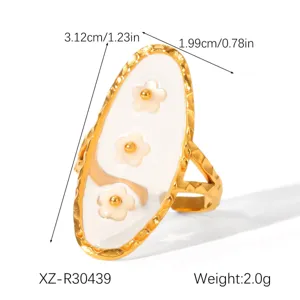 Detailed dimensions of gold-tone stainless steel ring with white flower enamel inlay.