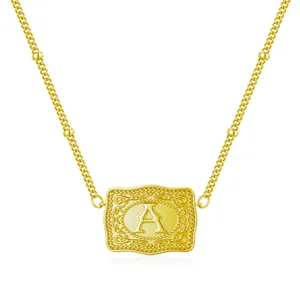 Macro view of golden belt buckle style pendant necklace with embossed letter A design