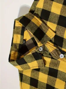 Detail shot of men's yellow black flannel plaid shirt collar and buttons close up view