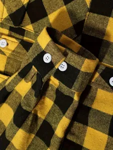 Close-up of yellow and black plaid long sleeve shirt cuff with white buttons detail.