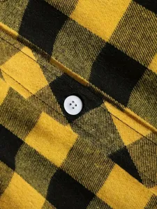 Men's yellow black flannel plaid shirt detail featuring soft fabric and classic button closure.