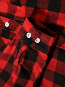 Detail shot of red black flannel plaid shirt, featuring white buttons and cuff design.