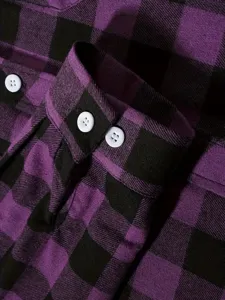 Close-up detail view of purple and black plaid flannel shirt cuff and classic white buttons.
