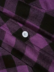 Detailed close-up showing the pocket flap and white button of men's purple plaid flannel shirt.