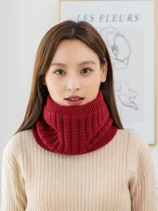 Close-up view of red cable knit neck warmer detail, cozy fleece winter accessory.