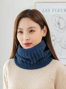 Detail shot of a cozy cable knit neck warmer in navy blue, thick fleece lined winter snood.