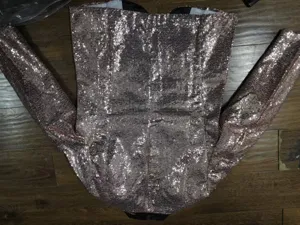 Detailed view of men's shiny sequin suit blazer, elegant party wear for nightclub stage shows.