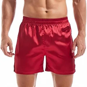 Men's solid red satin boxer shorts, silky smooth casual sleepwear underwear detail.