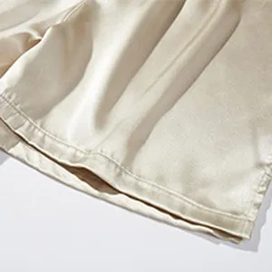 Smooth satin fabric detail of men's lounge boxer shorts showing fine stitching craftsmanship.