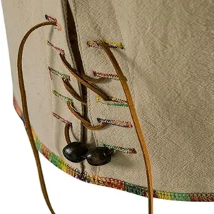 Close-up detail of men casual hippie shirt lacing leather cords wooden beads boho style