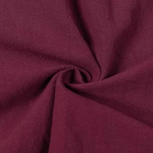 Close-up fabric detail showing soft burgundy cotton linen texture, breathable and comfortable.