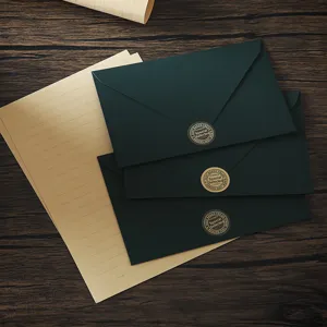 Detail view of dark green envelopes and lined craft letter paper set with retro sealing stickers.