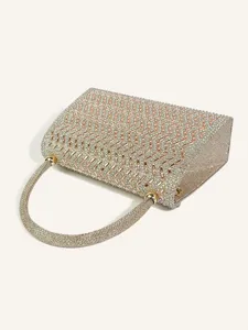 Close-up detail of a sparkling rhinestone evening handbag with geometric crystal pattern.