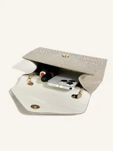 Sparkling rhinestone evening clutch bag with elegant chain and magnetic snap closure interior.