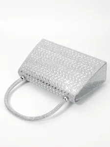 Silver rhinestone evening bag detail, sparkling crystal clutch handbag close up shot.